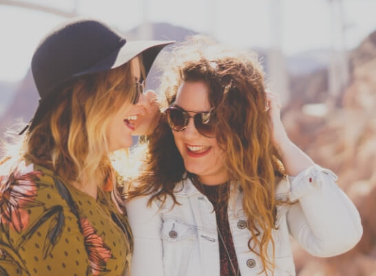 Two young women smiling and laughing