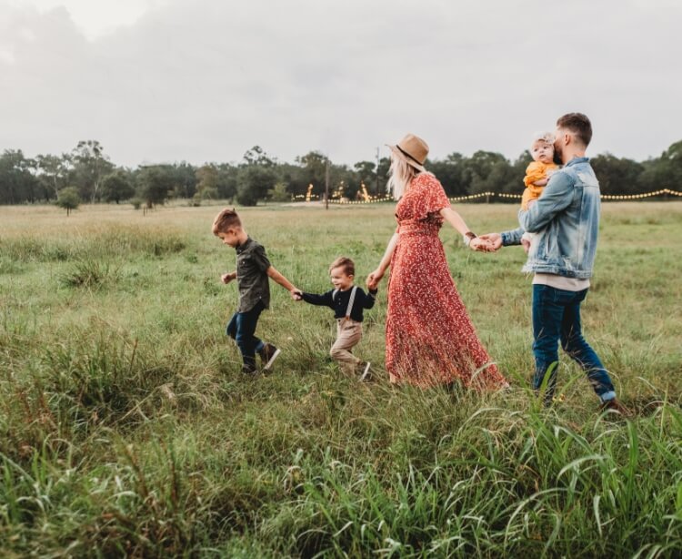 Family of five in a grassy field